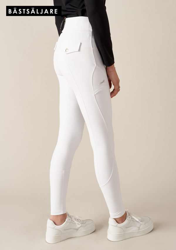 best seller -Vita tävlingsbyxor. Bekväma ridbyxor med hög midja och skulpterande passform. Tillverkade i fyrvägsstretch för optimal rörelsefrihet, med en mobilficka med lock och broderad häst. Helskodda med grip för rätt friktion i sadeln. True to size och med en Stay-in-place garanti som säkerställer att byxorna sitter uppe oavsett kroppsform