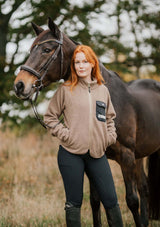 stable fleece i varm beige med svart ficka och detaljer i light gold. mjuk teddy vindtät med rundat avslut