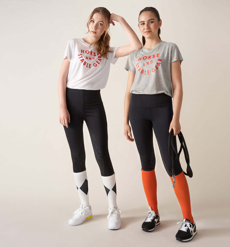 firm compression riding socks, stretchy and durable  polyamide and elastane. orange.firm compression , stretchy and durable blend of polyamide and elastane. orange. long compression comfortable sporty stylish riding socks. with lope logo. girls wearing competition socks, the core riding tights leggings and the stable t-shirtfirm compression riding socks, stretchy and durable  orange. long compression comfortable sporty stylish riding socks. orange kompressions ridstrumpa one size hållbar bekväm