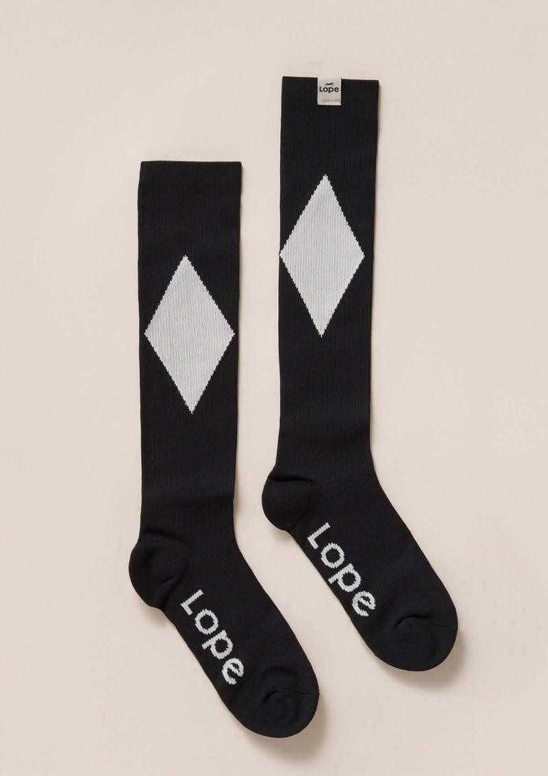 firm compression riding socks, stretchy and durable blend of polyamide and elastane. black and white