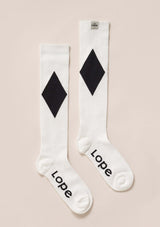 firm compression riding socks, stretchy and durable blend of polyamide and elastane. white with black romb firm compression riding socks, stretchy and durable blend of polyamide and elastane. solid black. knee high long comfortable compression socks. white lope logo. stylish, performance enhancing sport socks